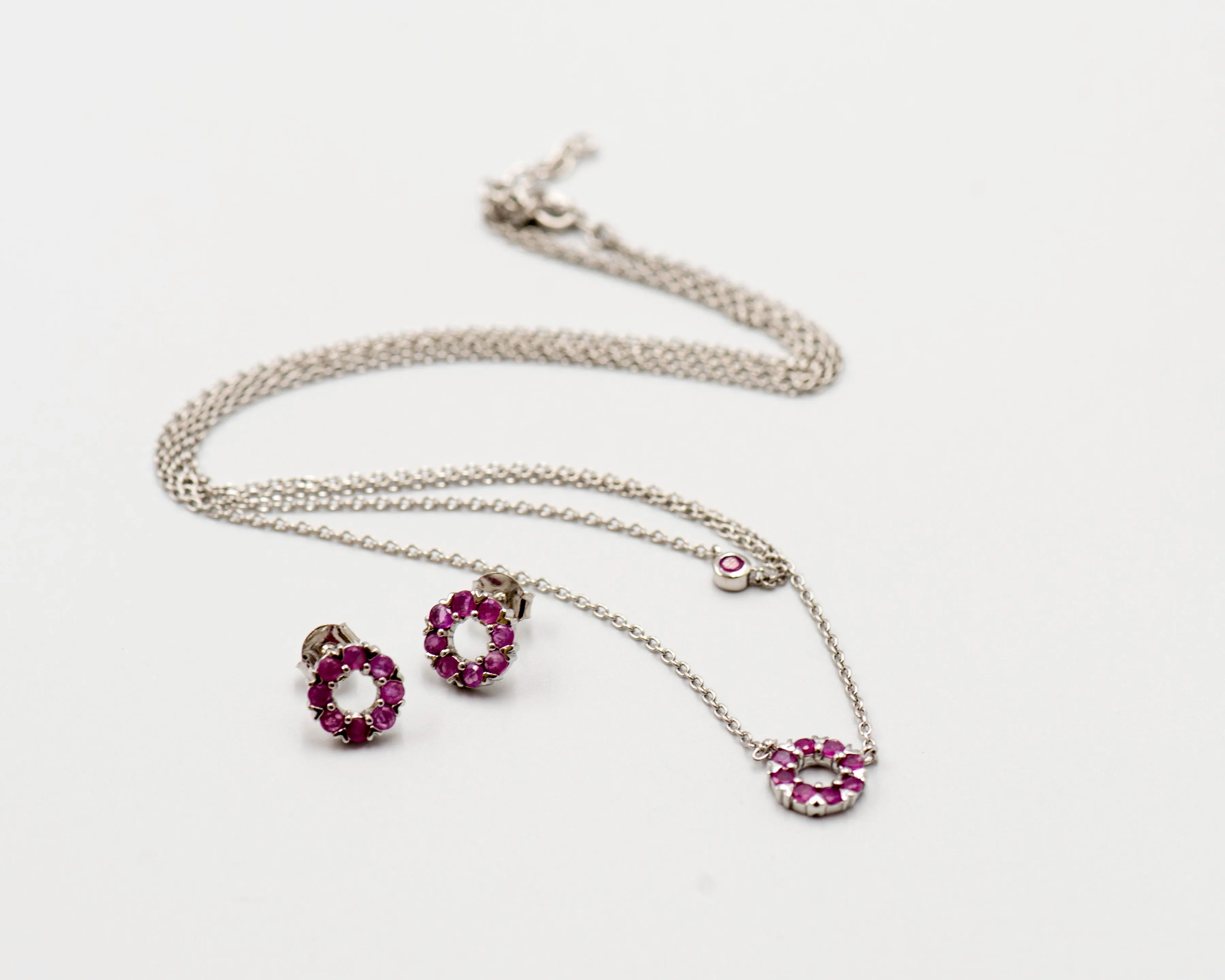 131 "Elegant silver round earrings and chain set, featuring a combination round pendant with July ruby stones.