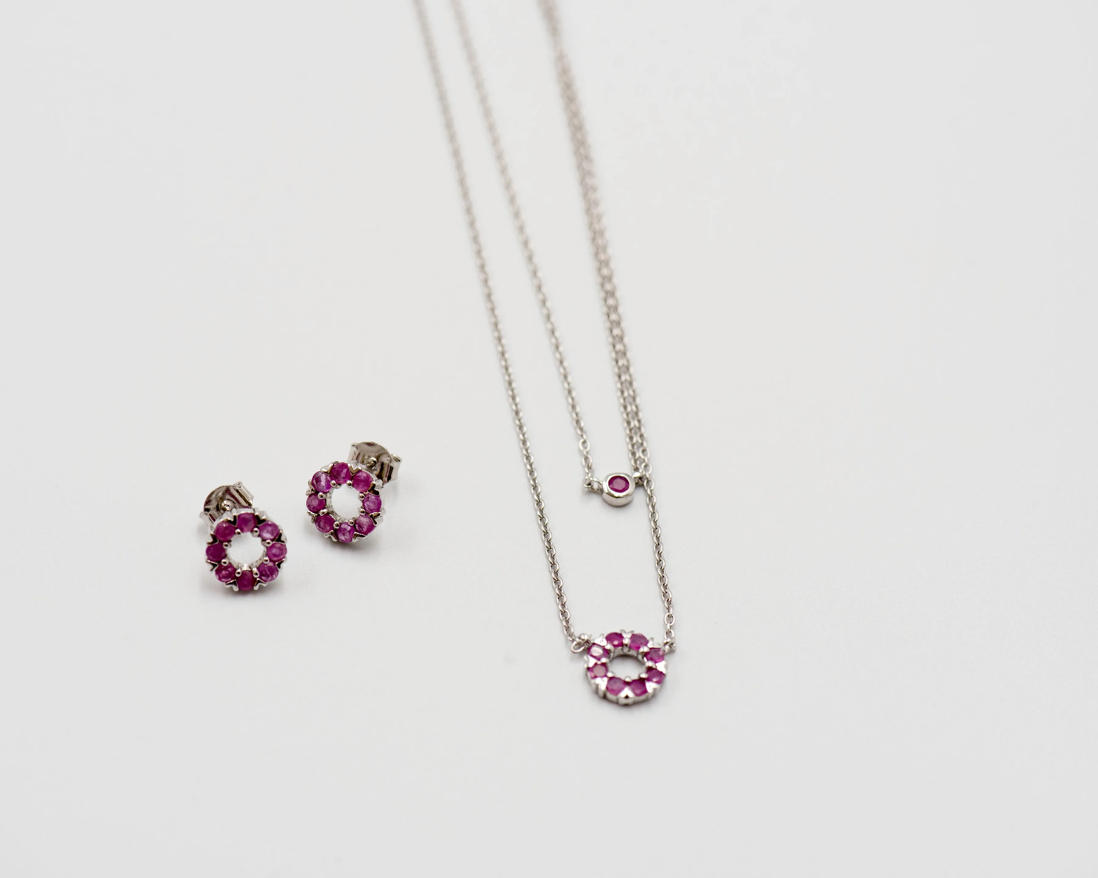 131 "Elegant silver round earrings and chain set, featuring a combination round pendant with July ruby stones.