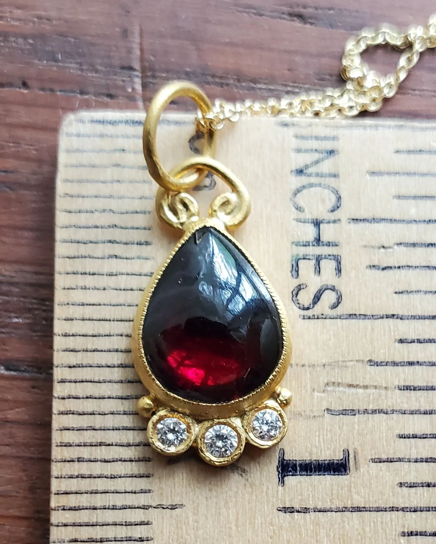 Prehistoric Works 24K Gold pendant with garnet & diamonds